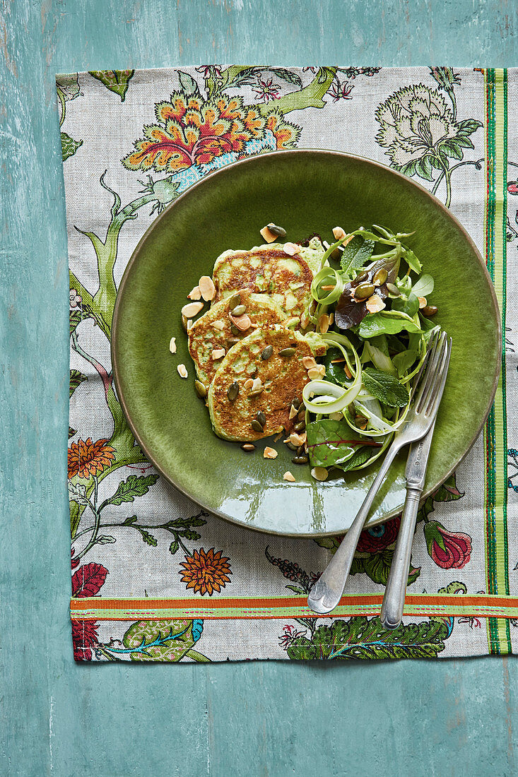 Courgette fritters with a courgette ribbon salad with toasted almonds and pumkin seeds