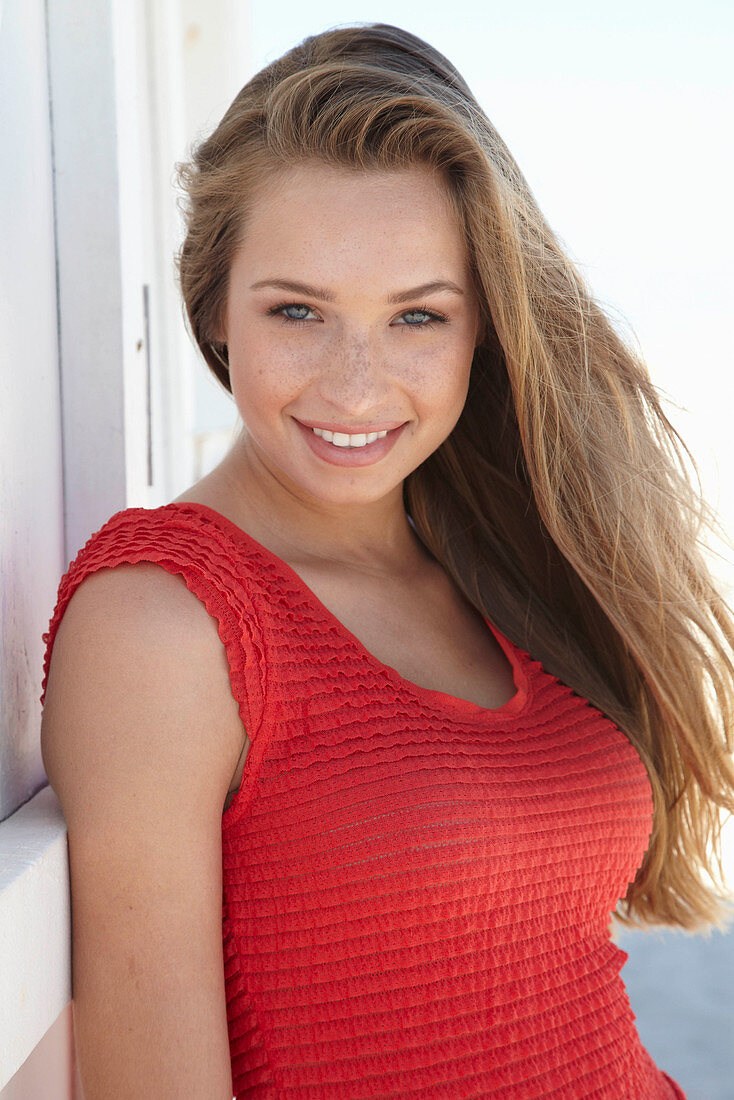 A young blonde woman wearing a red dress