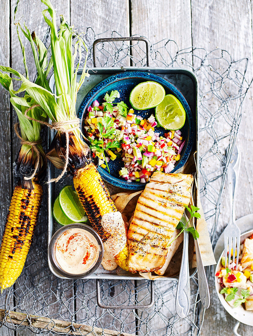 Grilled salmon and corn on the cob with Mexican salad