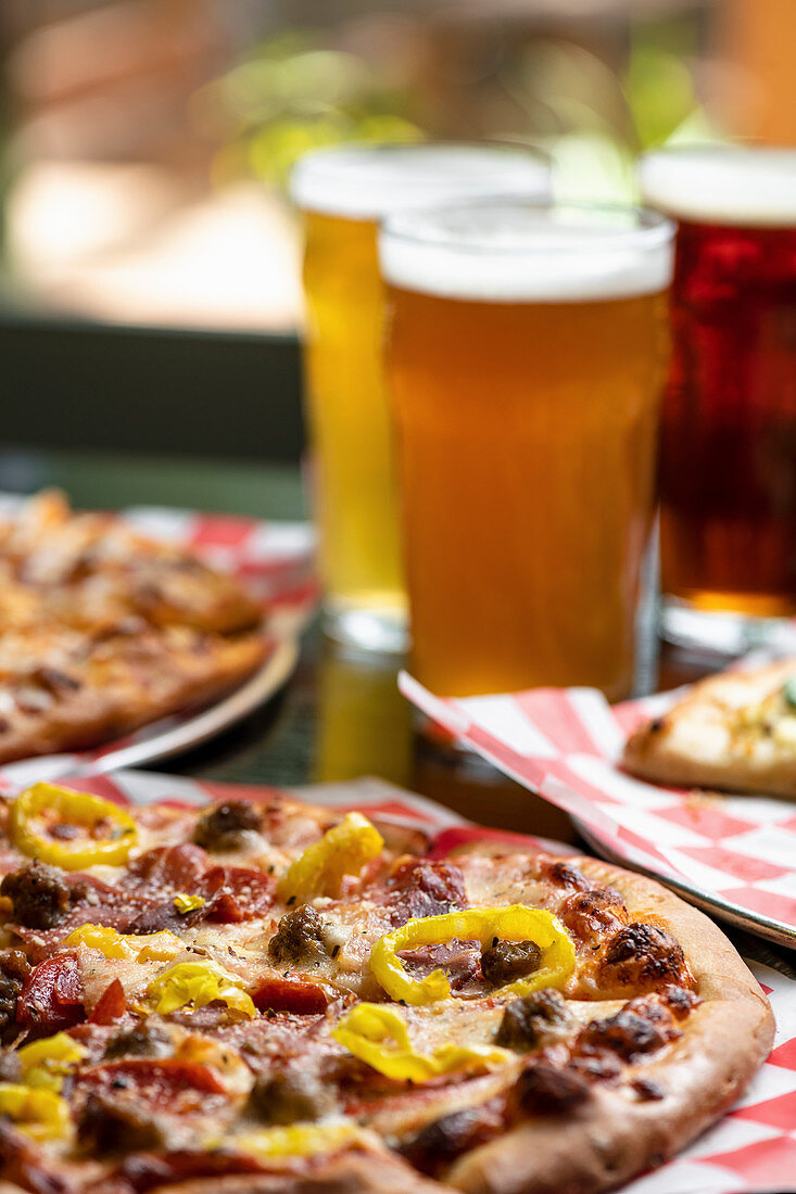 Pizza and beer on a restaurant table