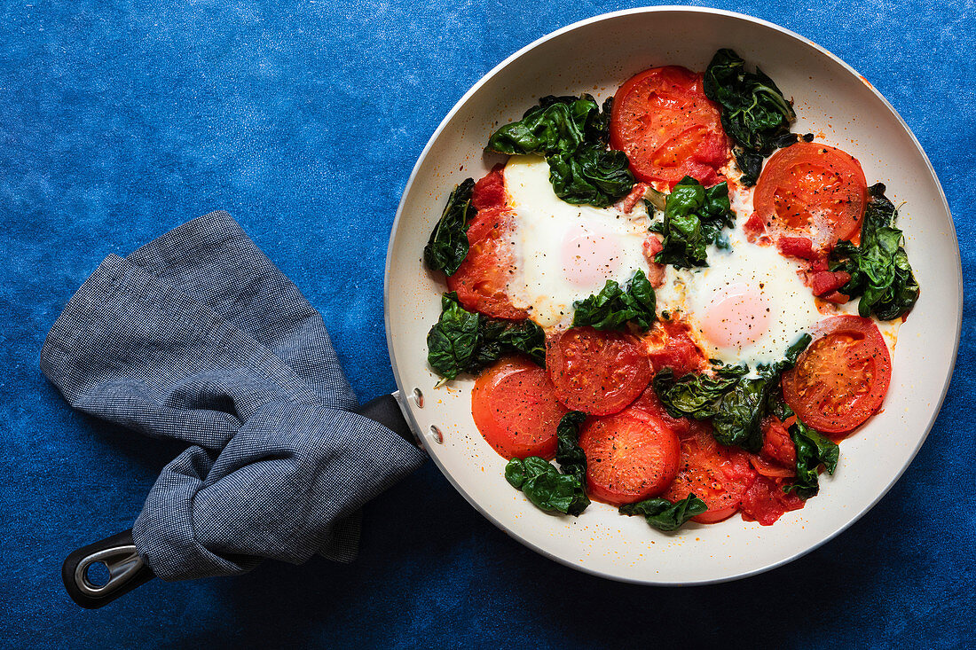 Cooked breakfast of eggs, tomatoes and silverbeet