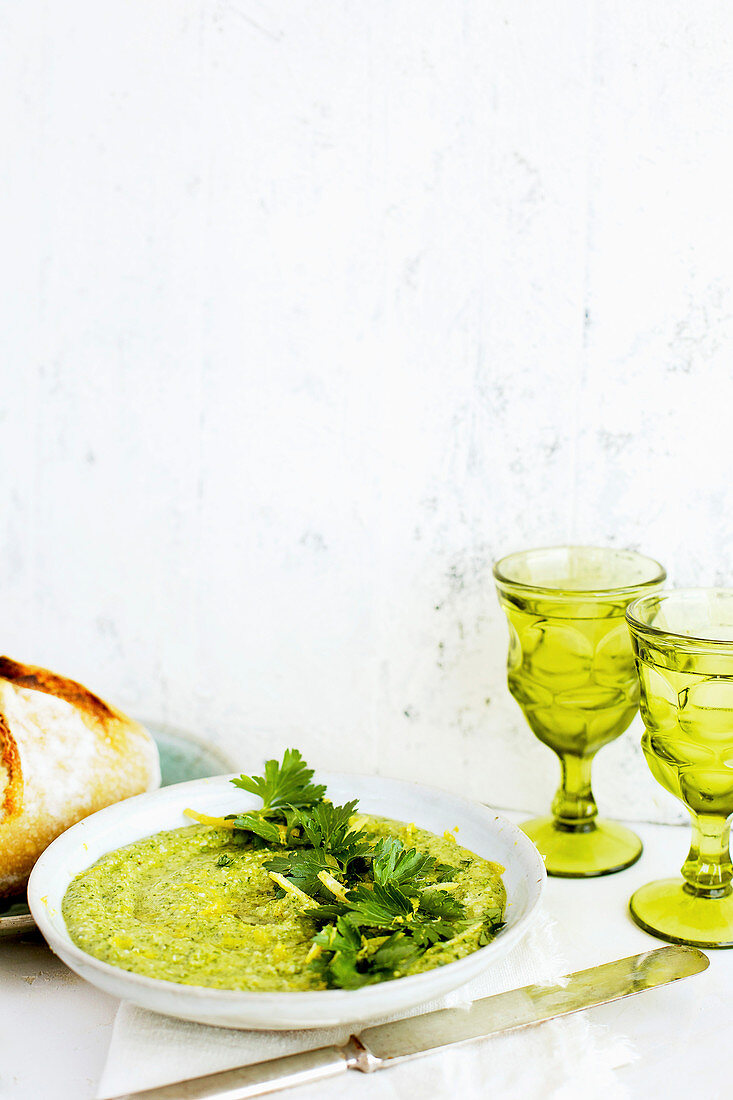 Italian Parsley and Lemon Pesto served in a ceramic bowl with sourdough bread and wine