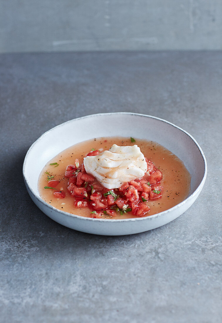 Poached cod in a tomato and ginger broth