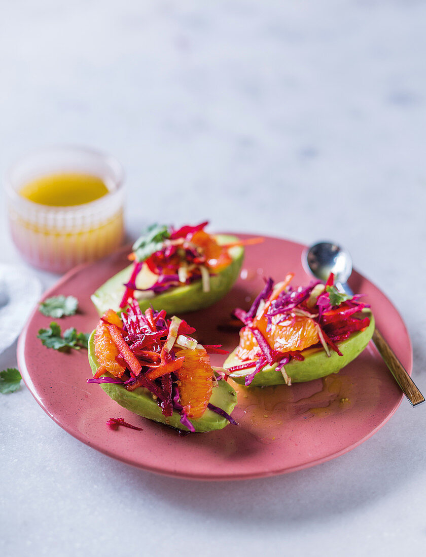 Avocado filled with vegetables and citrus fruit