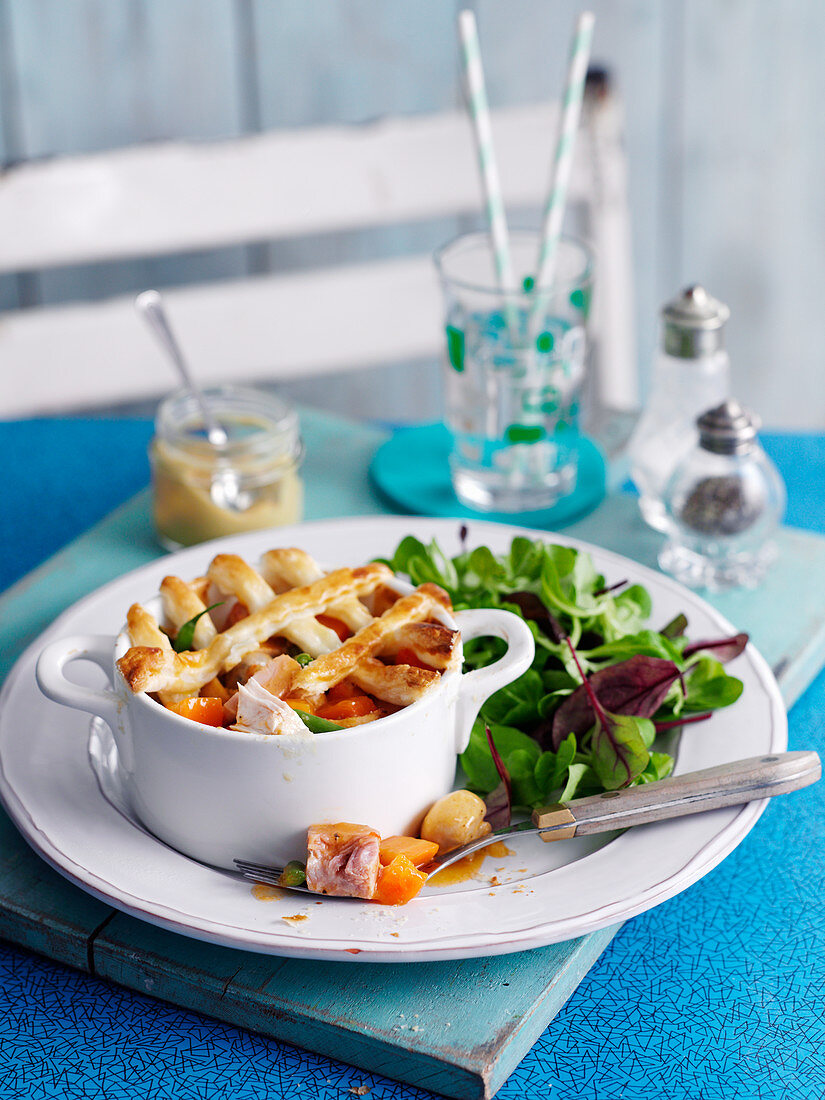 Chicken and ham pie with mixed salad leaves