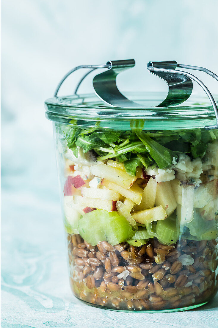 A layered spelt, apple and celery salad in a jar