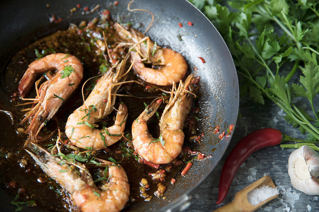 Prawns cooked in a pan with chilli and garlic
