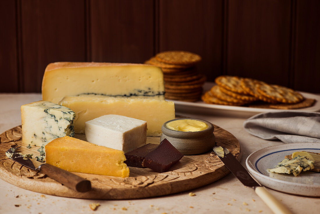 A cheese platter with butter and crackers