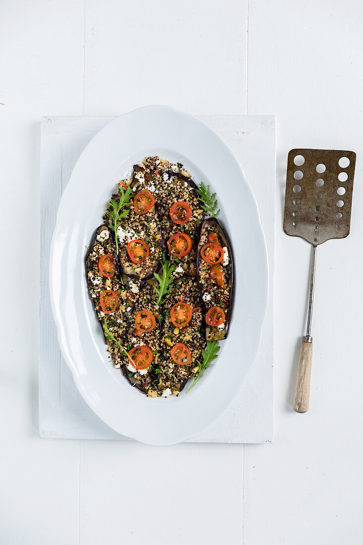 This is a baked aubergine dish topped with a mix of quinoa, fresh herbs and feta cheese (gluten free)