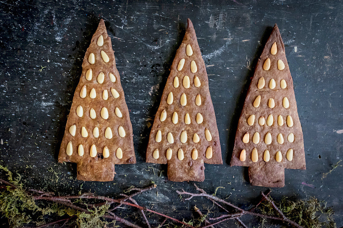 Gingerbread Christmas tree biscuits decorated with pine nuts