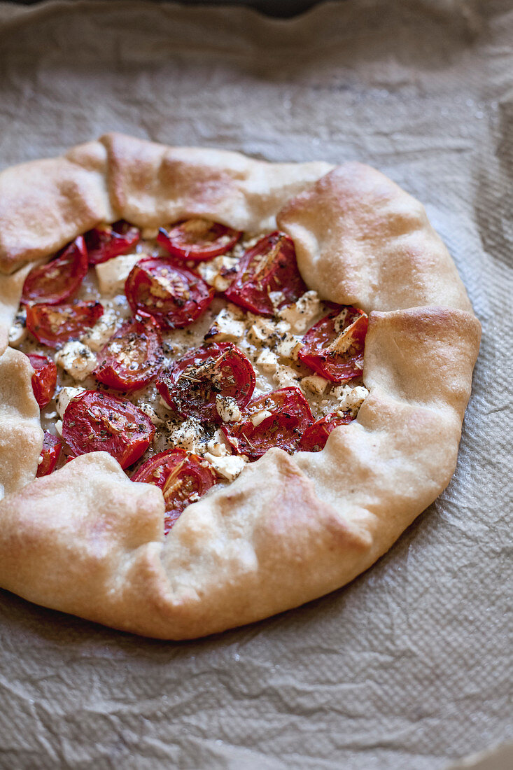 Galeta with tomatoes, goat cheese and Provencal herbs on parchment