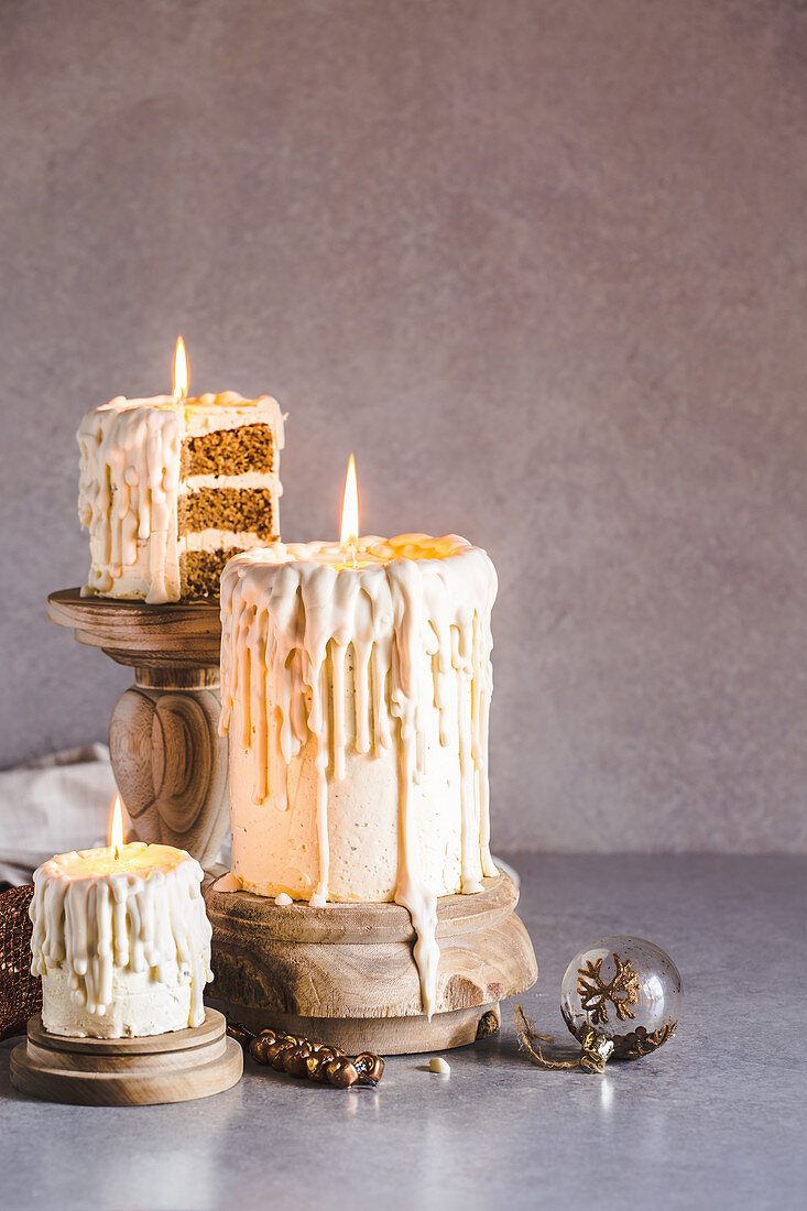 Dripping white chocolate 'candle' cakes with eggnog sponge and nutmeg-rum buttercream icing