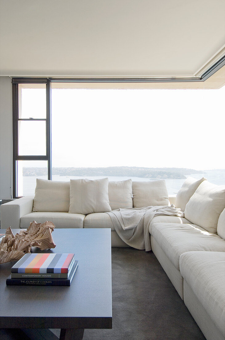 Cream sofa in front of corner window with panoramic view