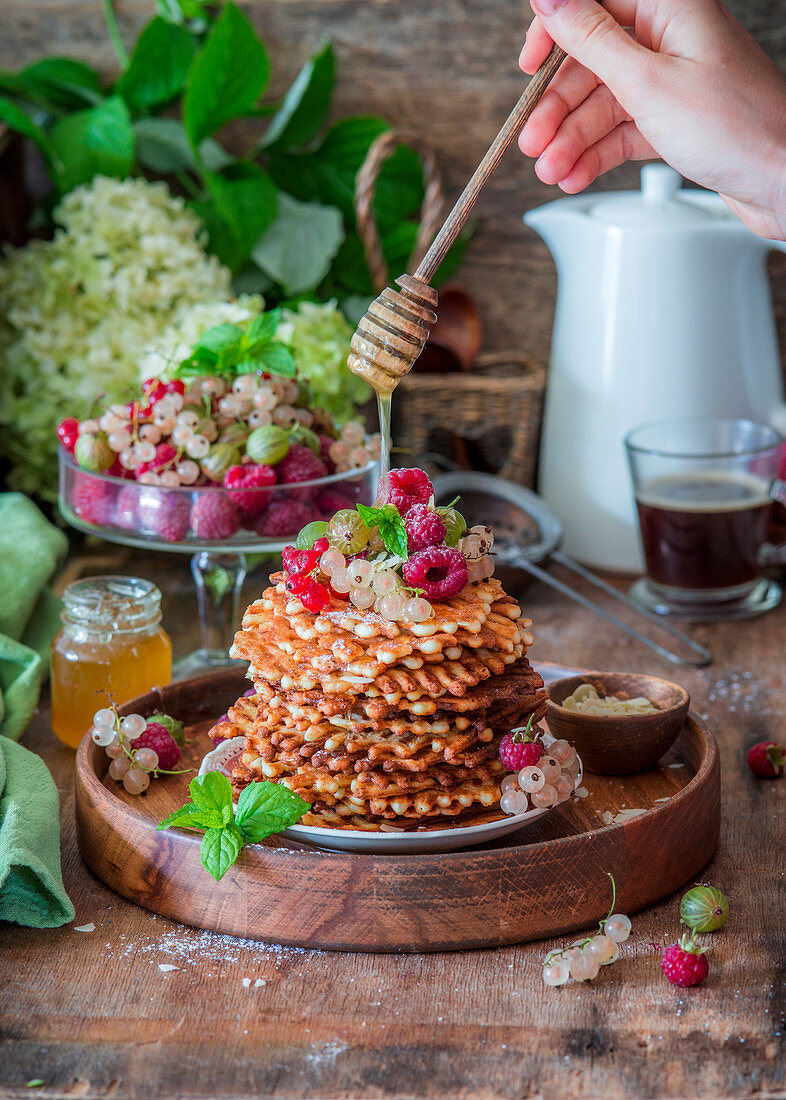 Thin waffles with berries and honey