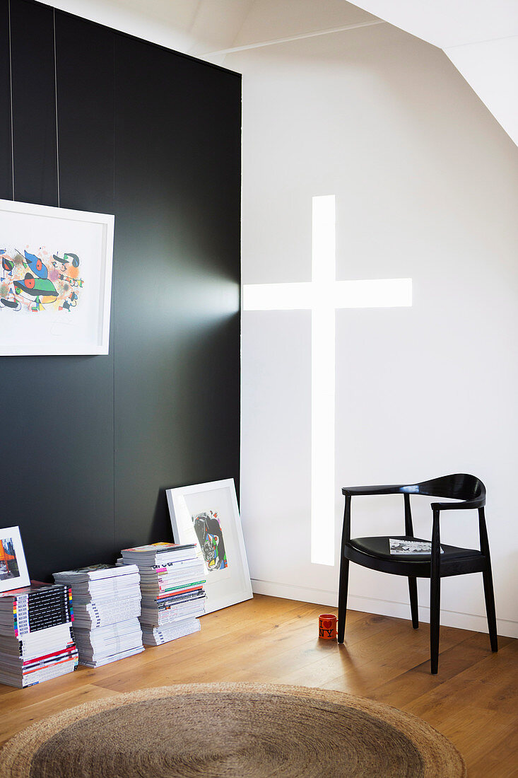 Light falls through the cross-shaped wall opening