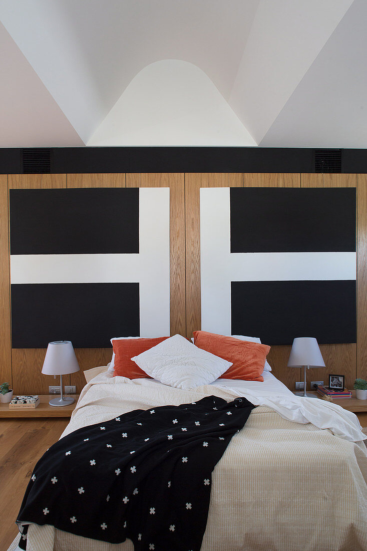 Diptych with cross motif above the bed in the simple bedroom