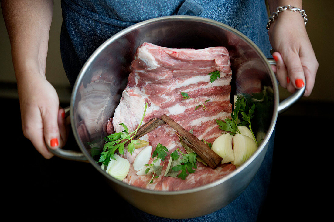 Raw pork ribs with ingredients in a pot