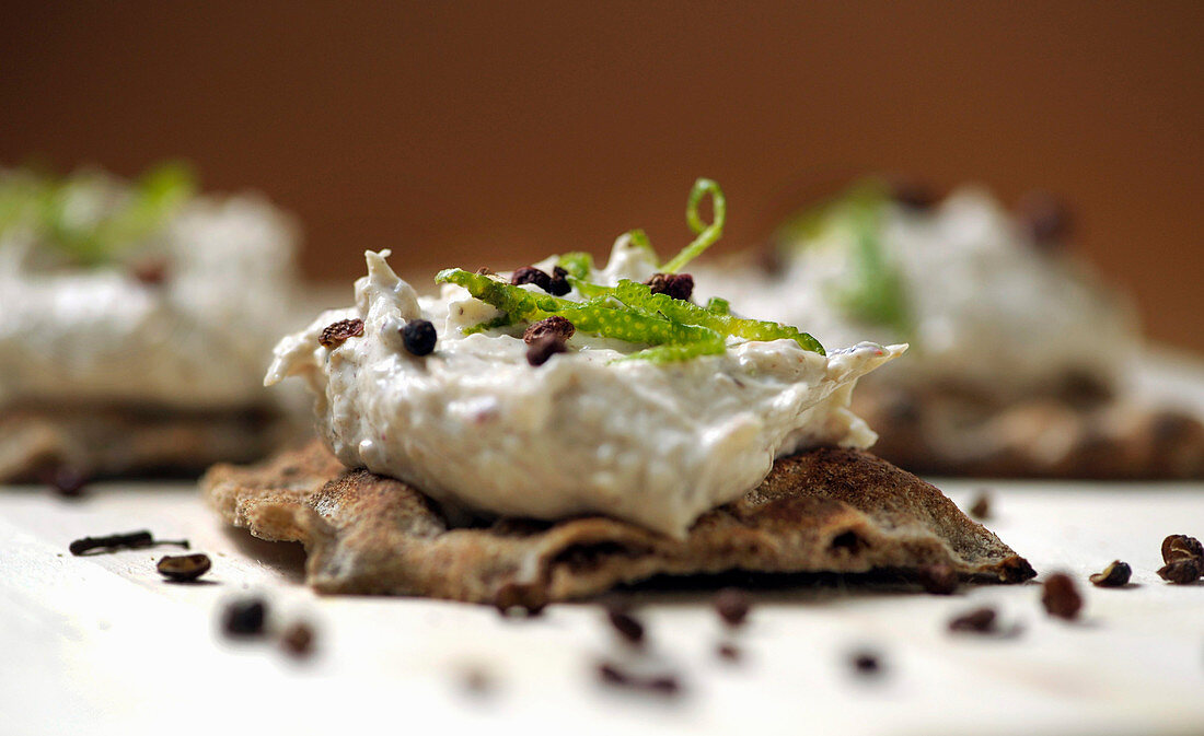 Crispbread with crab cream and Sichuan pepper (close-up)