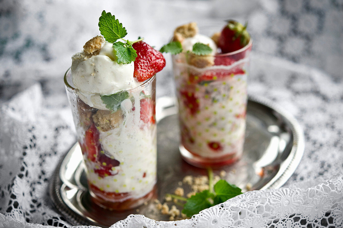 Strawberries marinated in elderflower syrup with ice cream