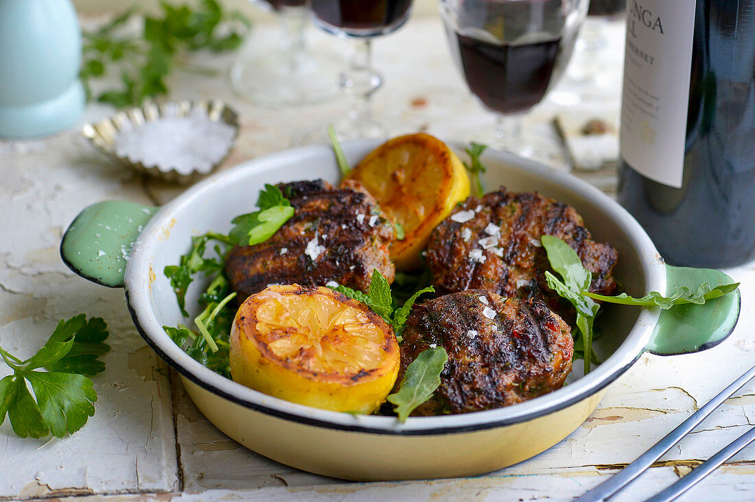Grilled lamb meatballs with halved lemons