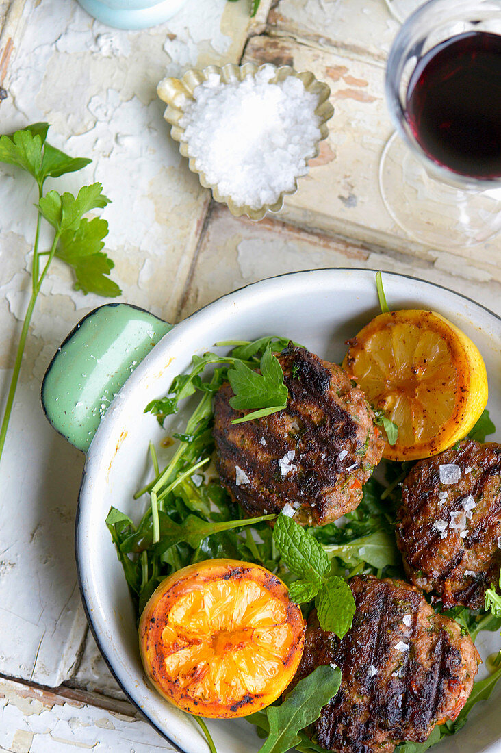 Grilled lamb meatballs with halved lemons