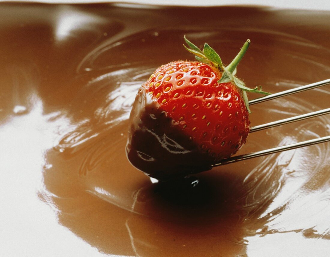Fresh Strawberry Dipping into Chocolate Sauce