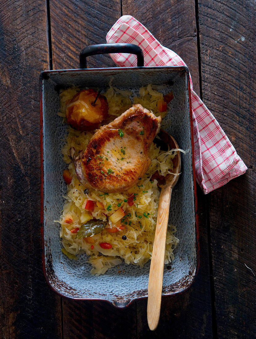 Pork chops with sauerkraut and baked apples