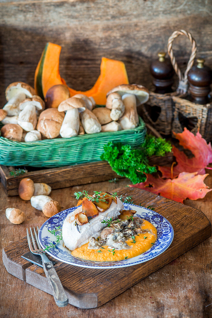 Roast chicken breast with pumpkin puree and creamy mushroom sauce