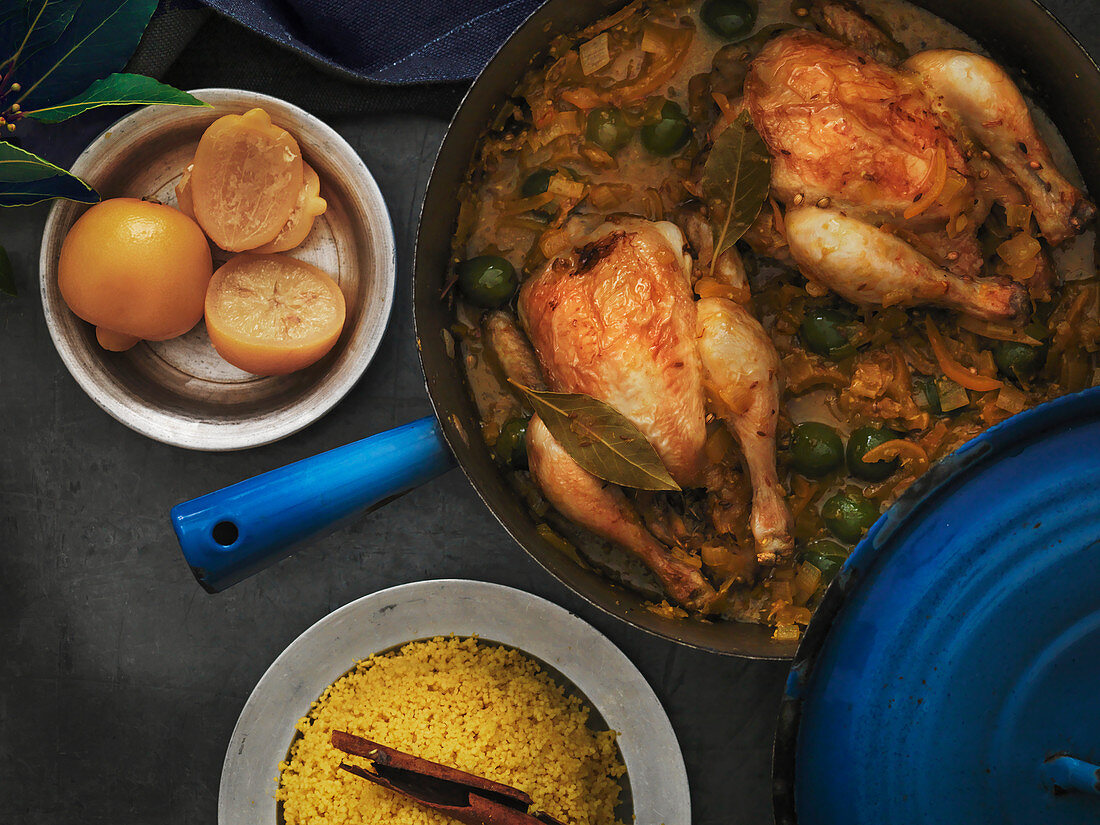 Baby Poussin Moroccan Tajine with green olives and bay leaves served with preserved lemons and cinnamon cous cous