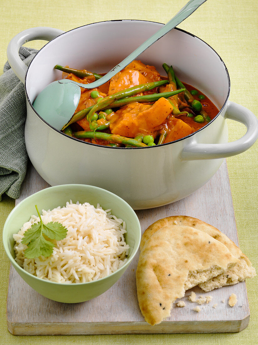 Butternut Squash curry with beans and peas and naan bread and rice