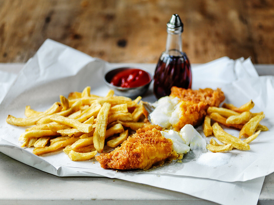 British fish and chips withy vinegar and tomato ketchup