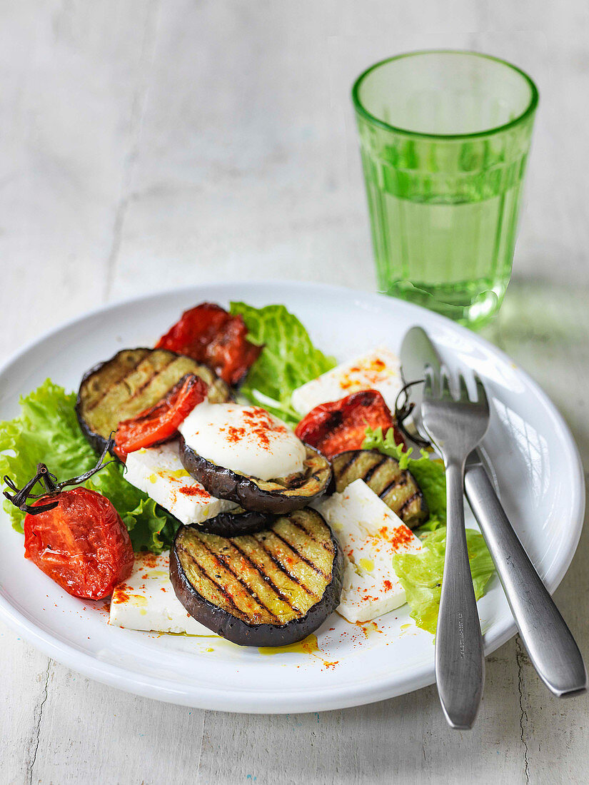 Char grilled aubergine salad with roast tomatoes lettuce and feta cheese