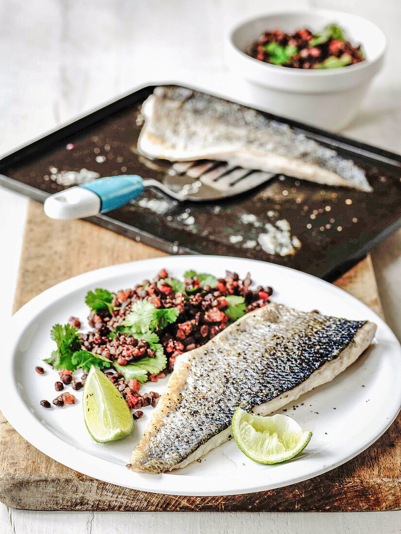 Sea bass fillets with lentils abd coriander with lime wedges