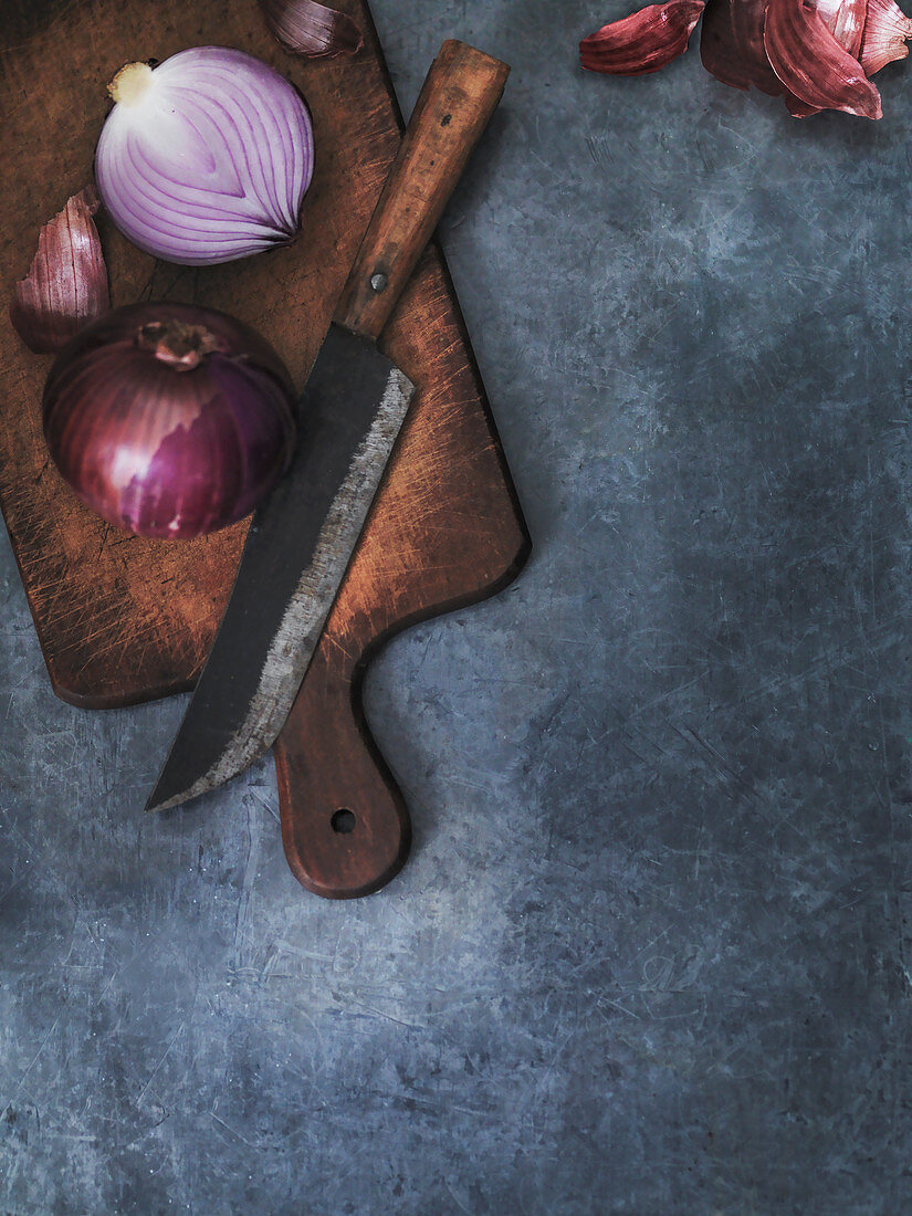 Red Onion knife and chopping board background for text or recipes