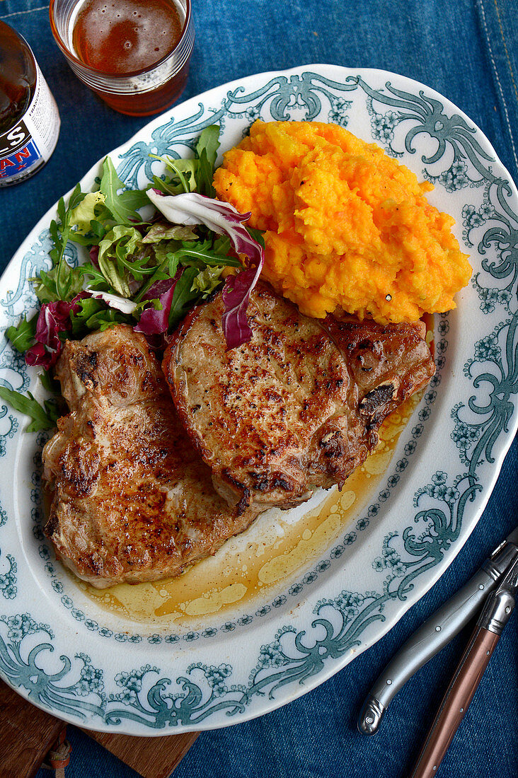 A pork chop with root vegetable purée
