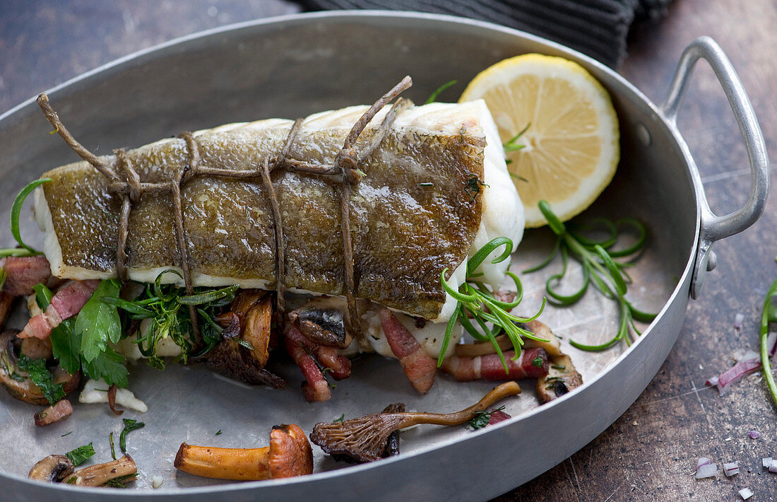 Cod with pancetta and mushrooms in a roasting tin