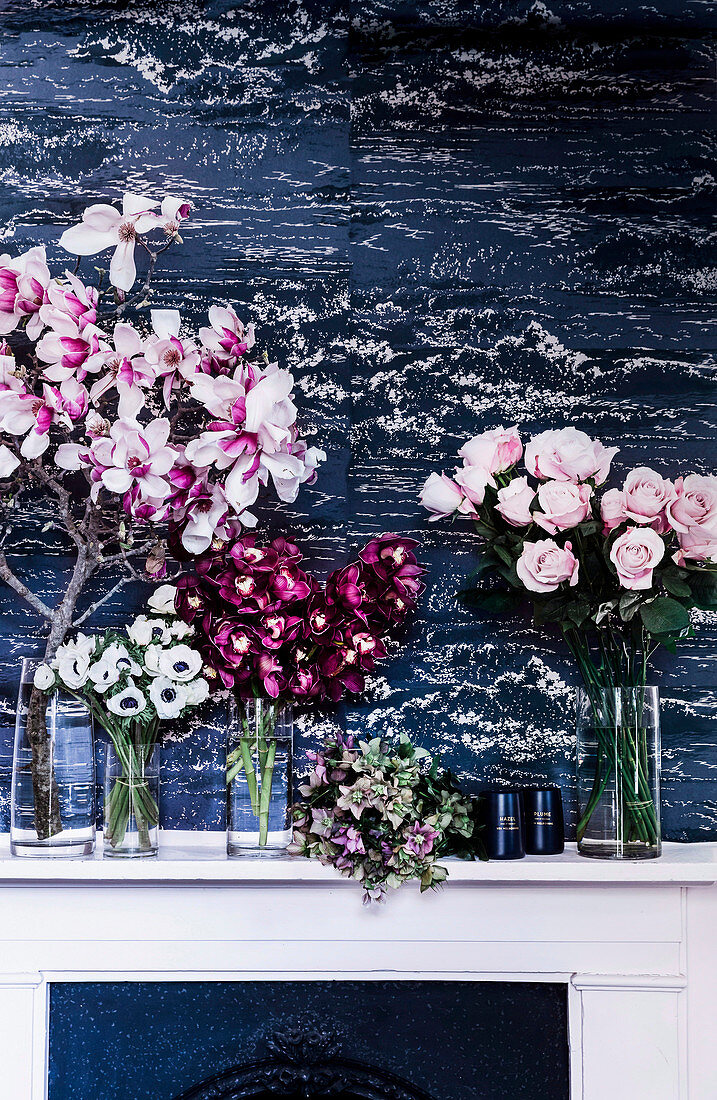 Flower decoration with magnolias and roses in gals vases