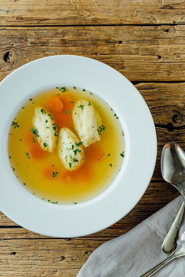 Traditional chicken soup with carrot and dumplings