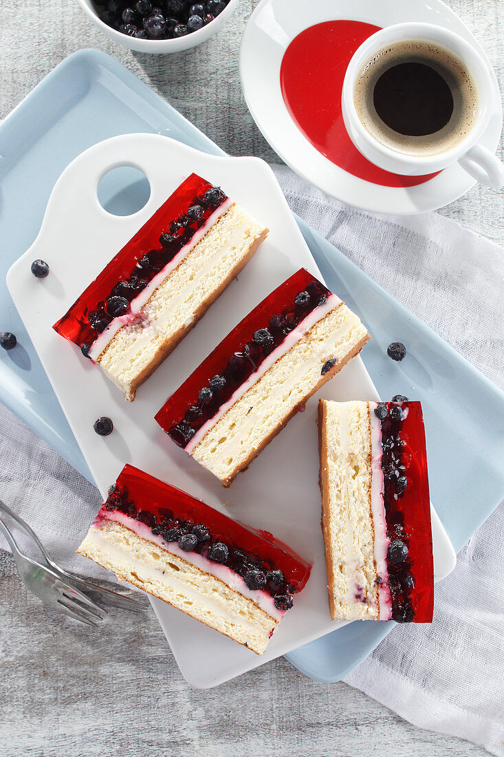 A multi-layered cake with jelly and blueberries