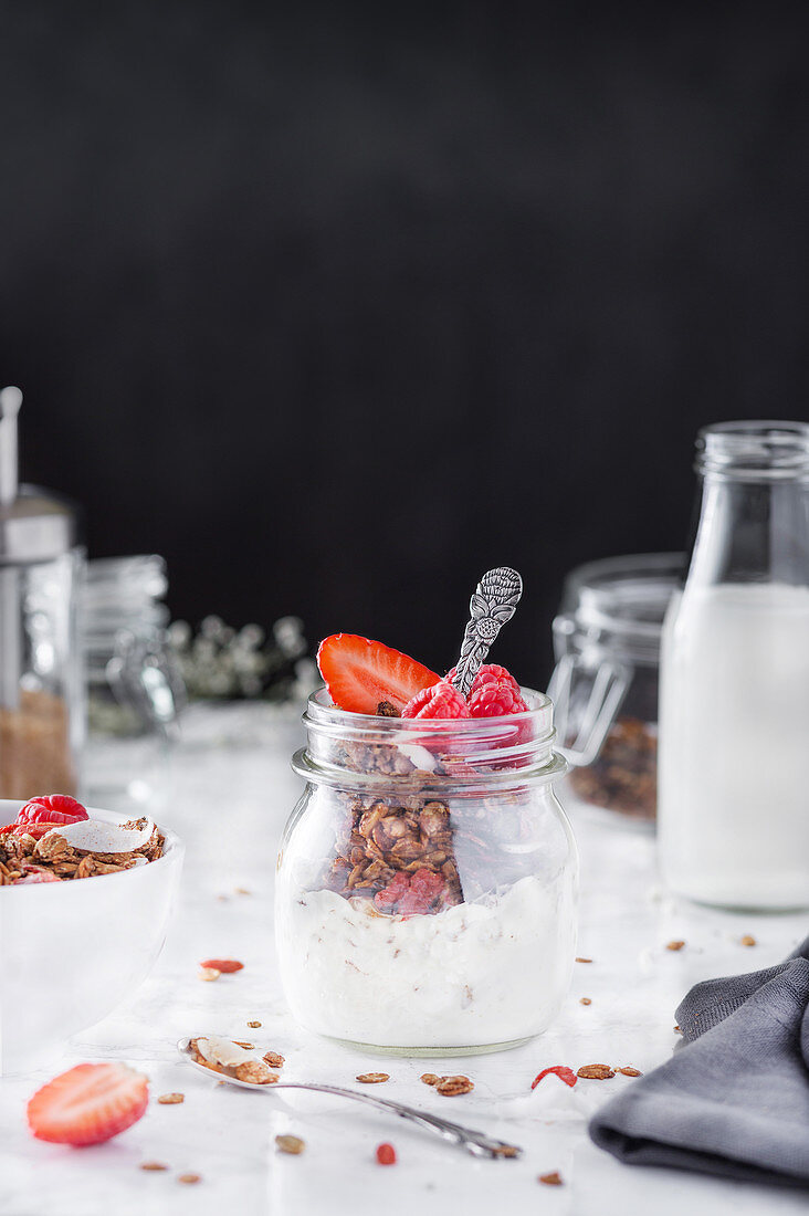 Tasty nutrient breakfast with granola, cream, and strawberry