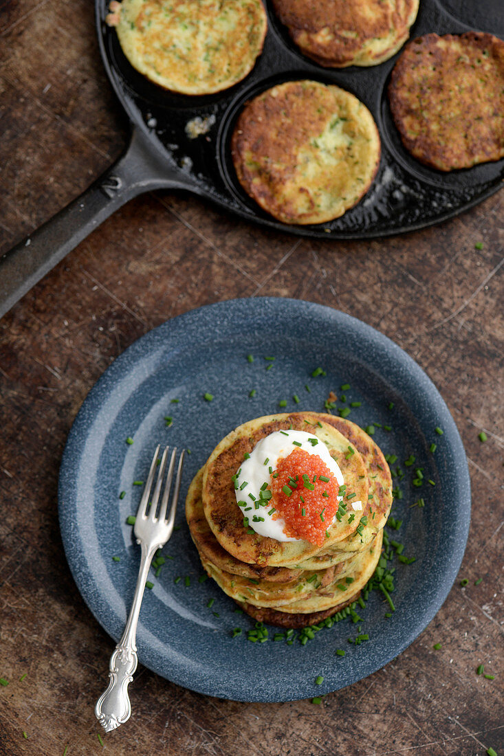 Pancakes with sour cream, chives and caviar