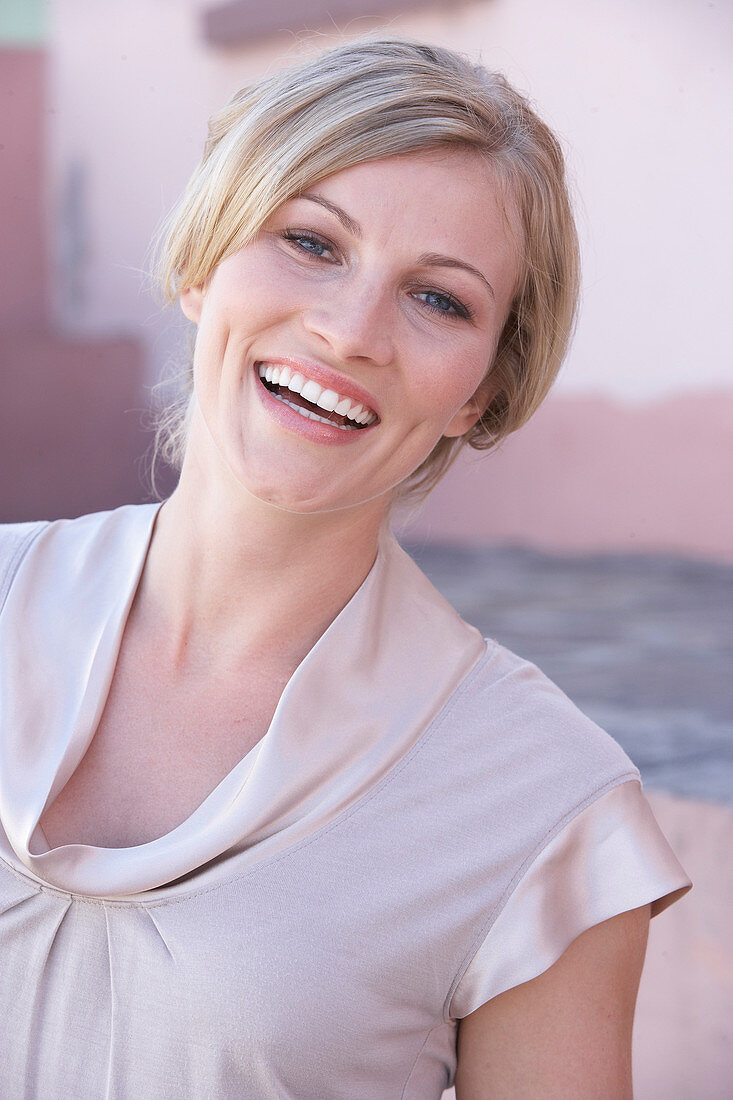 A blonde woman wearing a light blouse