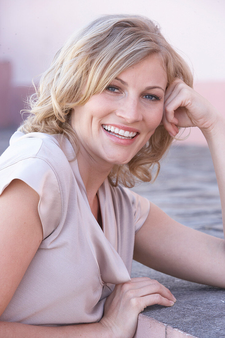 A blonde woman wearing a light blouse