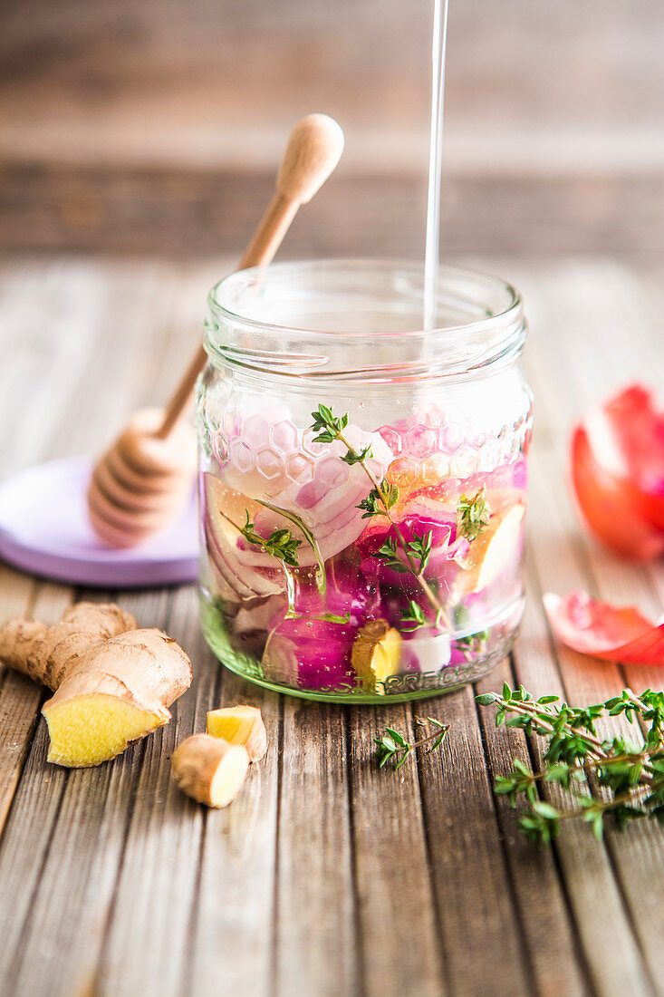 Homemade cough medicine with honey, onions, thyme and ginger