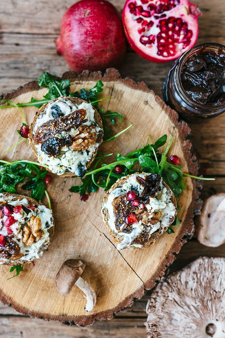 Bruschette with blue cheese, dry figgs and pomegranate