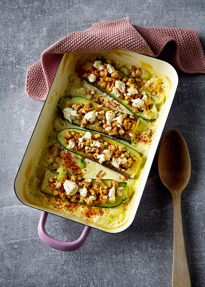 Stuffed courgettes with tofu and nuts on a bed of cream