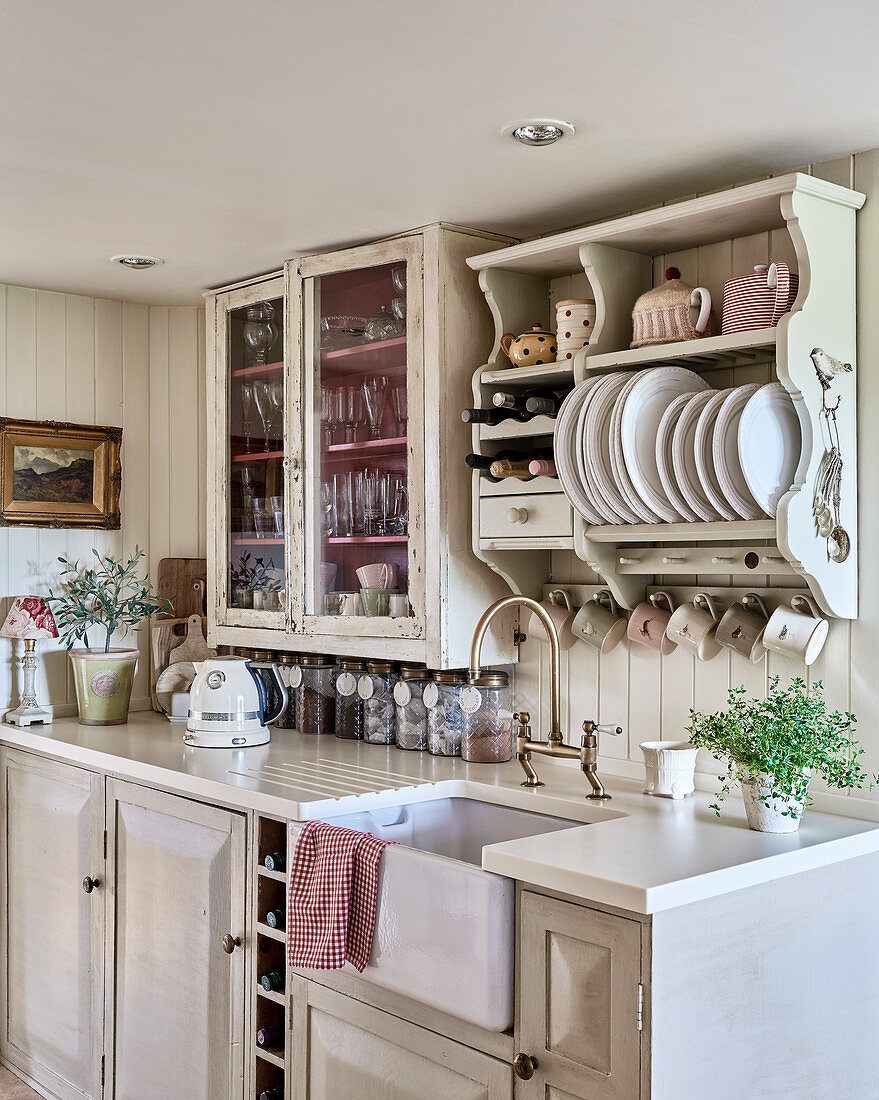 Plate rack and glass fronted cabinet above kitchen counter