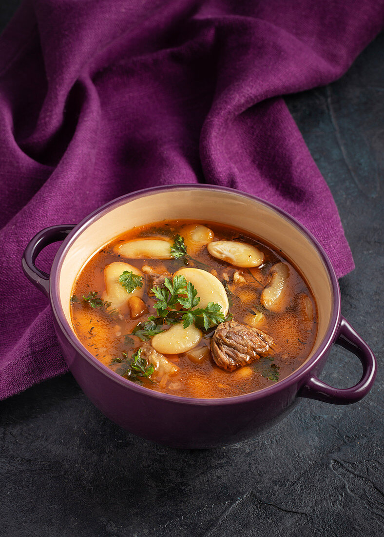 Beef and bean soup on purple background