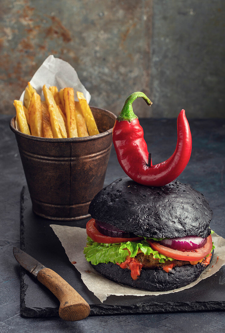 Purgatory burger and french fries on black slate