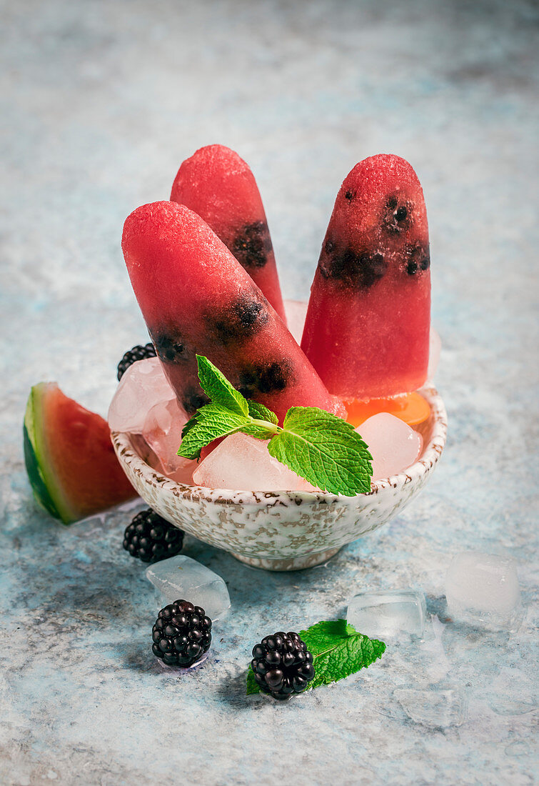 Watermelon blackberry popsicles in bowl with mint